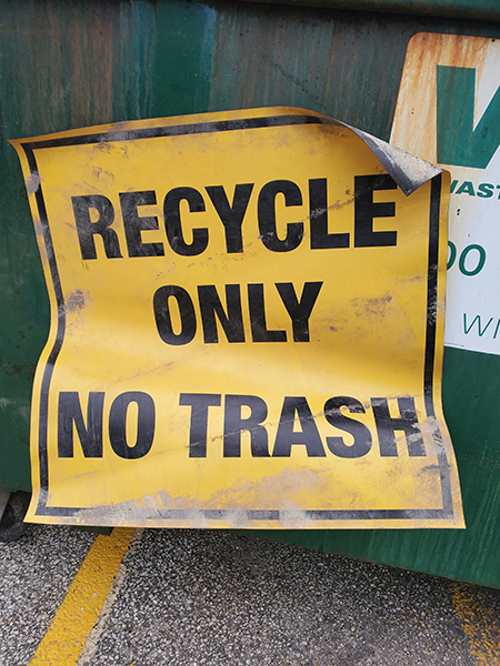 a sign on a dumpster that says "RECYCLE ONLY, NO TRASH"