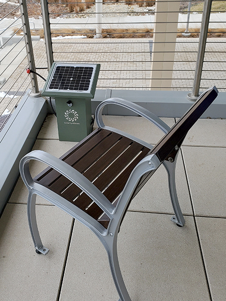 a chair next to a solar power charging station