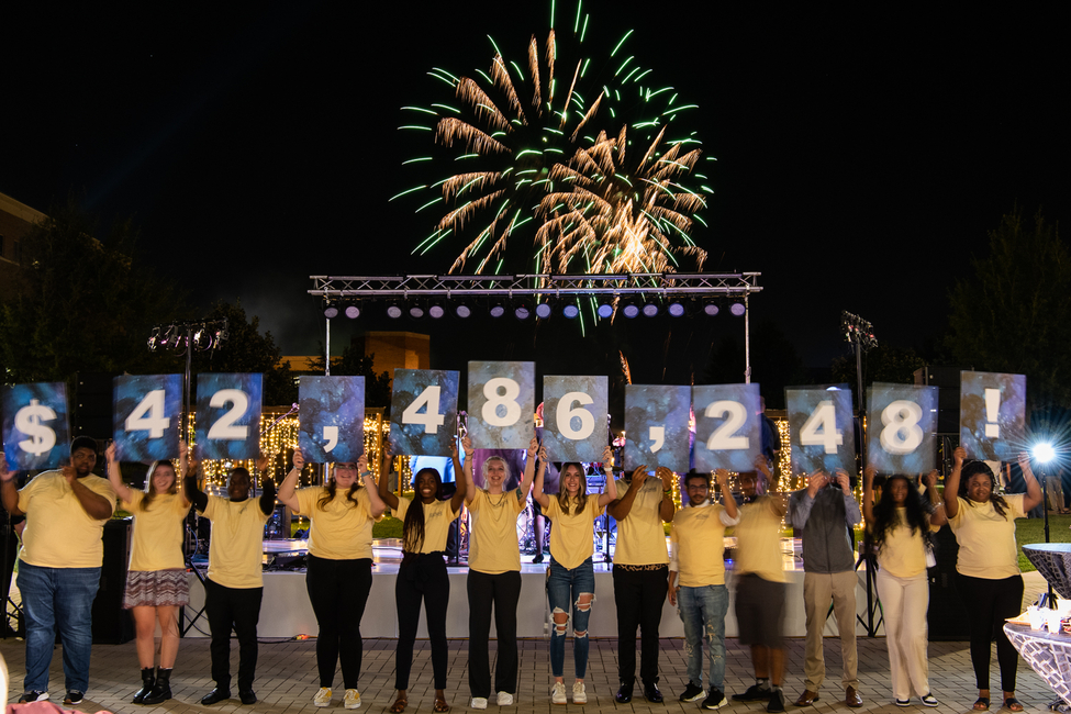 UIS students reveal the total amount raised through the Reaching Stellar Campaign during an event on campus Thursday night. 