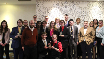 The UIS Model Illinois Government delegation poses for a group photo, holding awards.