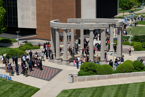birds eye view of the colonnade with graduates and their families hanging out before the ceremony