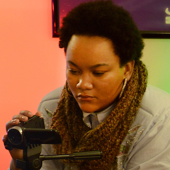 a female UIS student recording with a camera