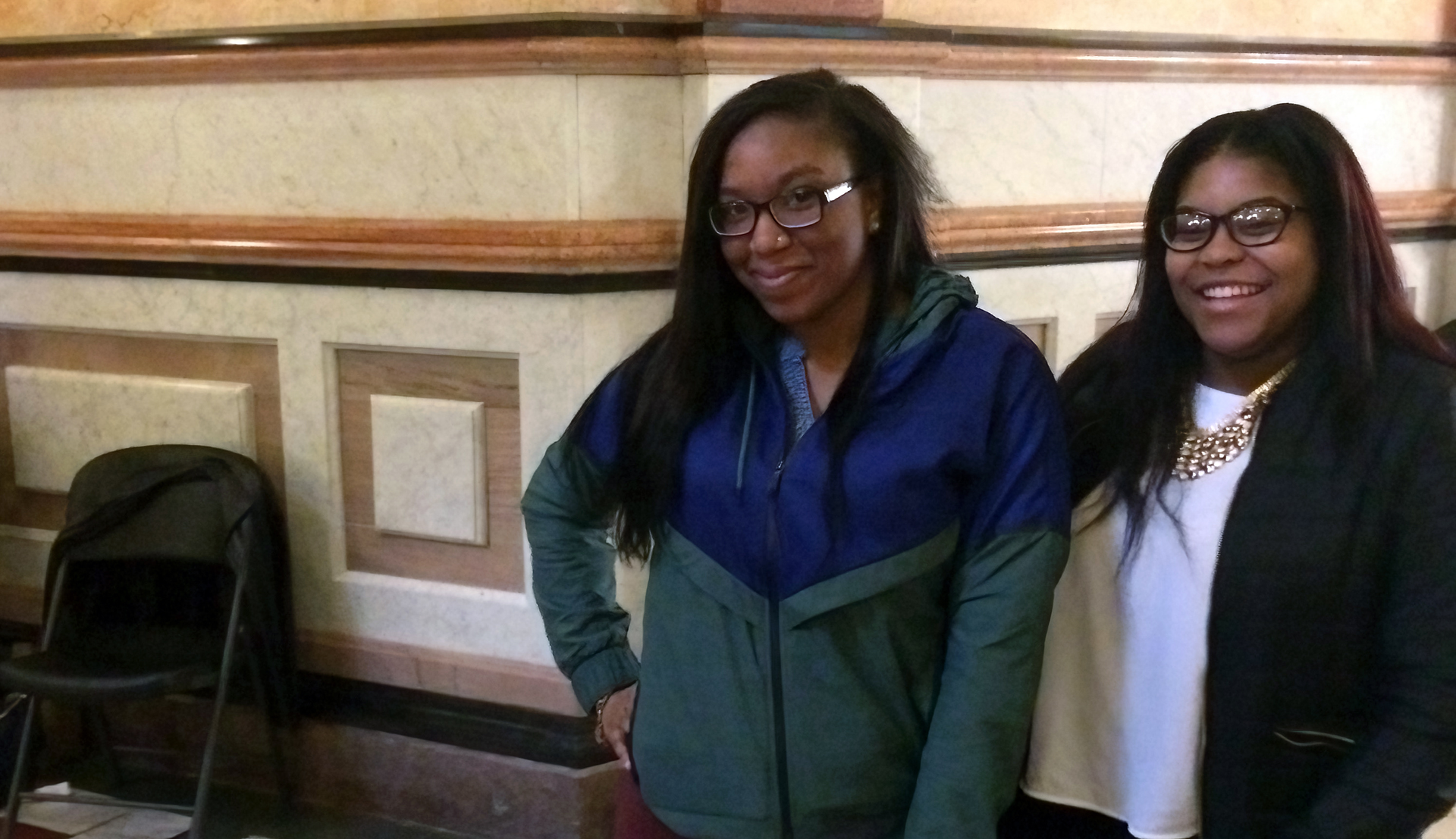 Two social work students smile in the state capitol building