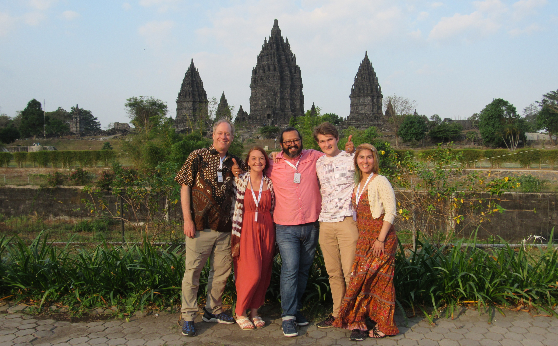Professor and four students pose in front of ancient Hindu temple in Indonesia