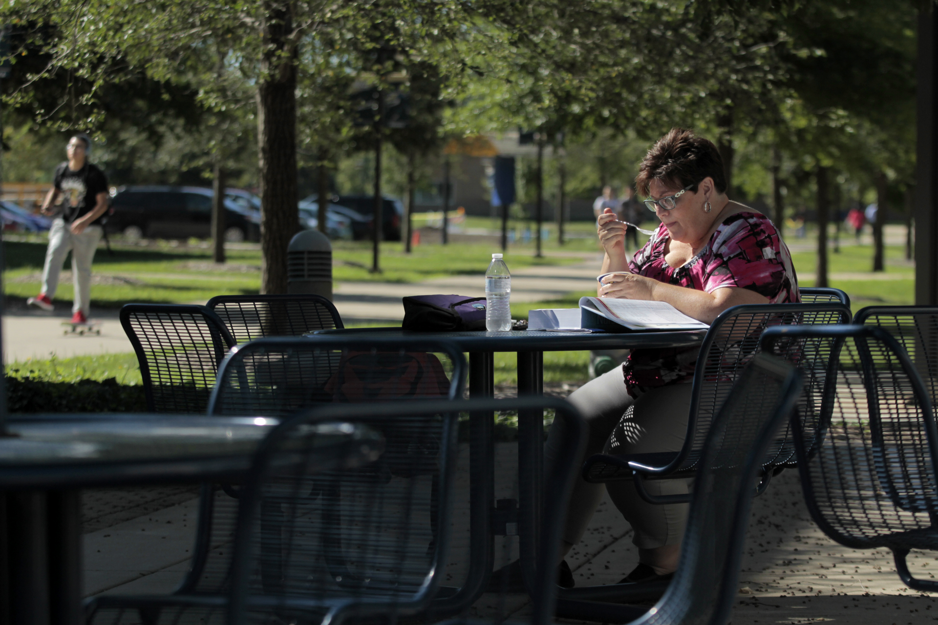 UIS student reading outside