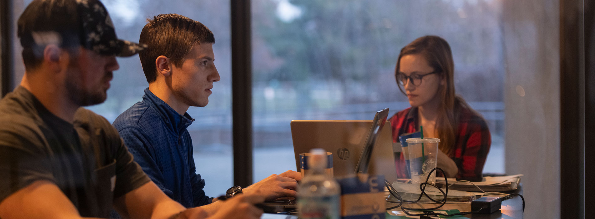 Students conferring in the library