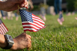 a tiny american flag being planted in the ground