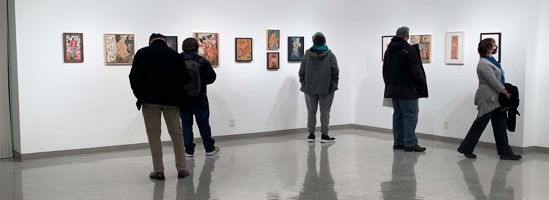 People looking at art in a gallery.