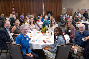 alumni and students posing for group photo at awards dinner