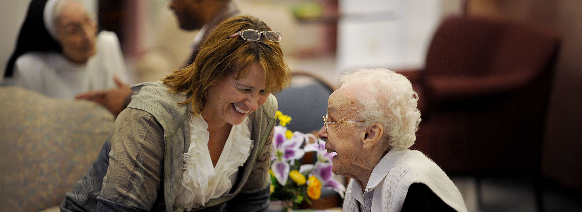 woman speaking with elderly woman