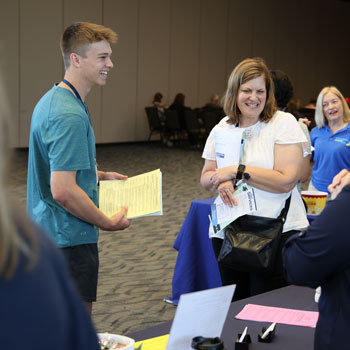 a student and his mother attending orientation
