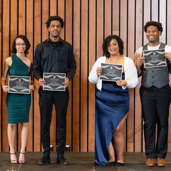 students holding up their awards