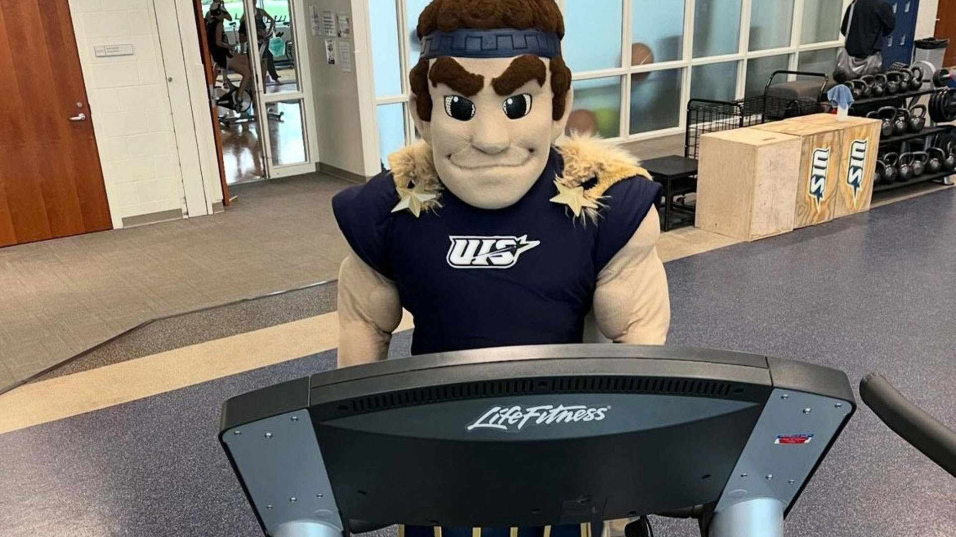 the UIS mascot running on a treadmill