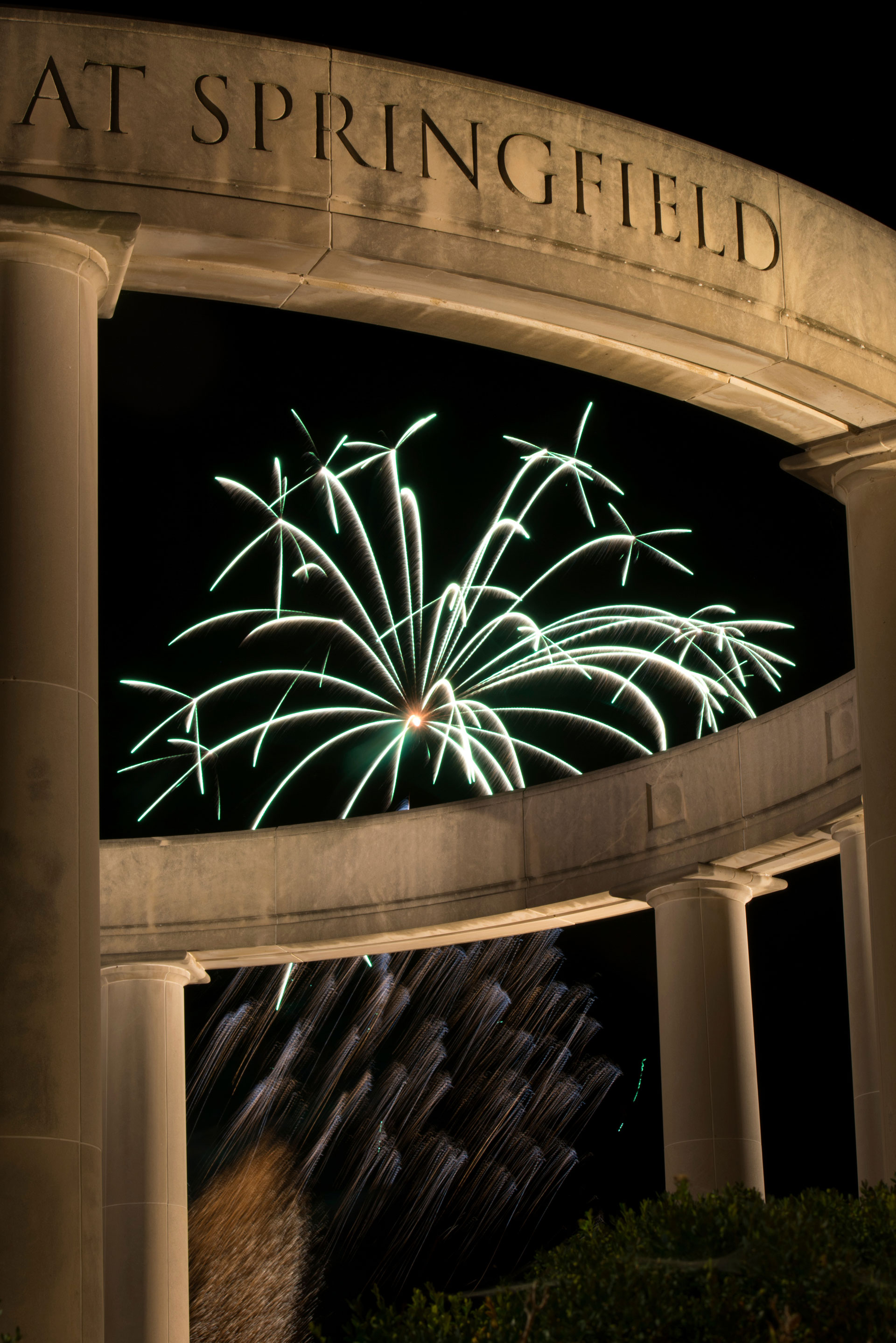 the colonnade in the foreground with fireworks going off in the background