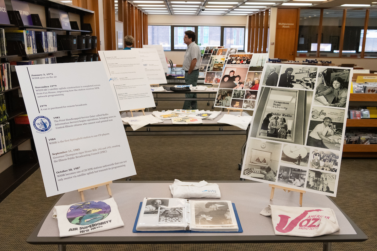 Radio that Listens to You exhibit with historical photographs and documents on display tables.