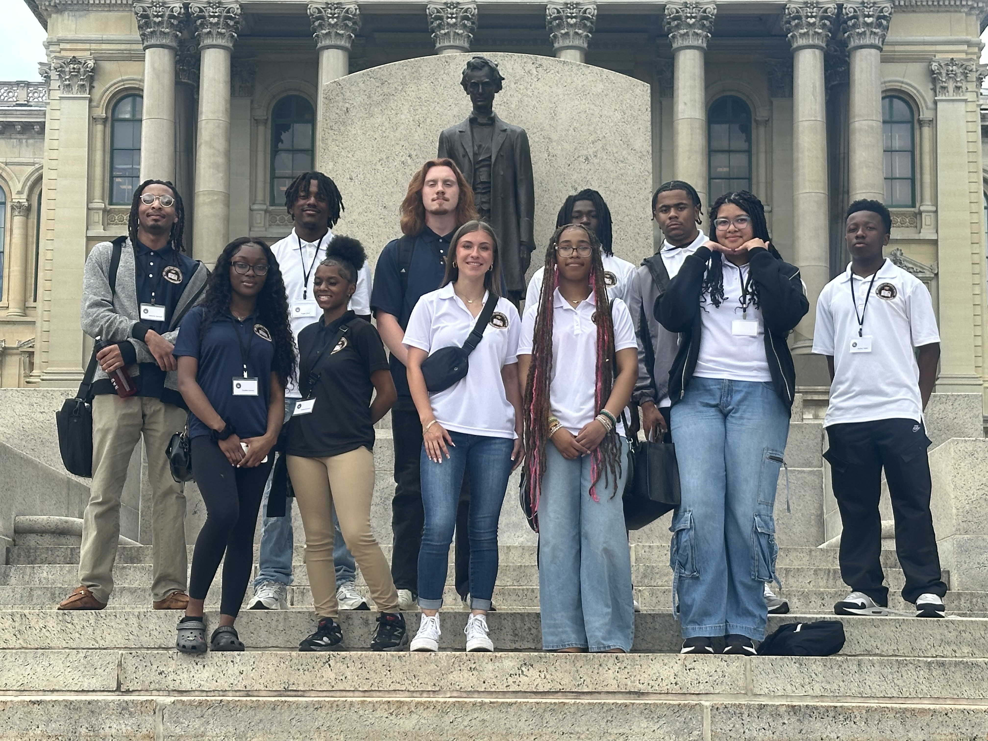 Group of students from the UIS Civic Camp standing on steps in front of a statue of Abraham Lincoln in front of the Illinois Capitol Building
