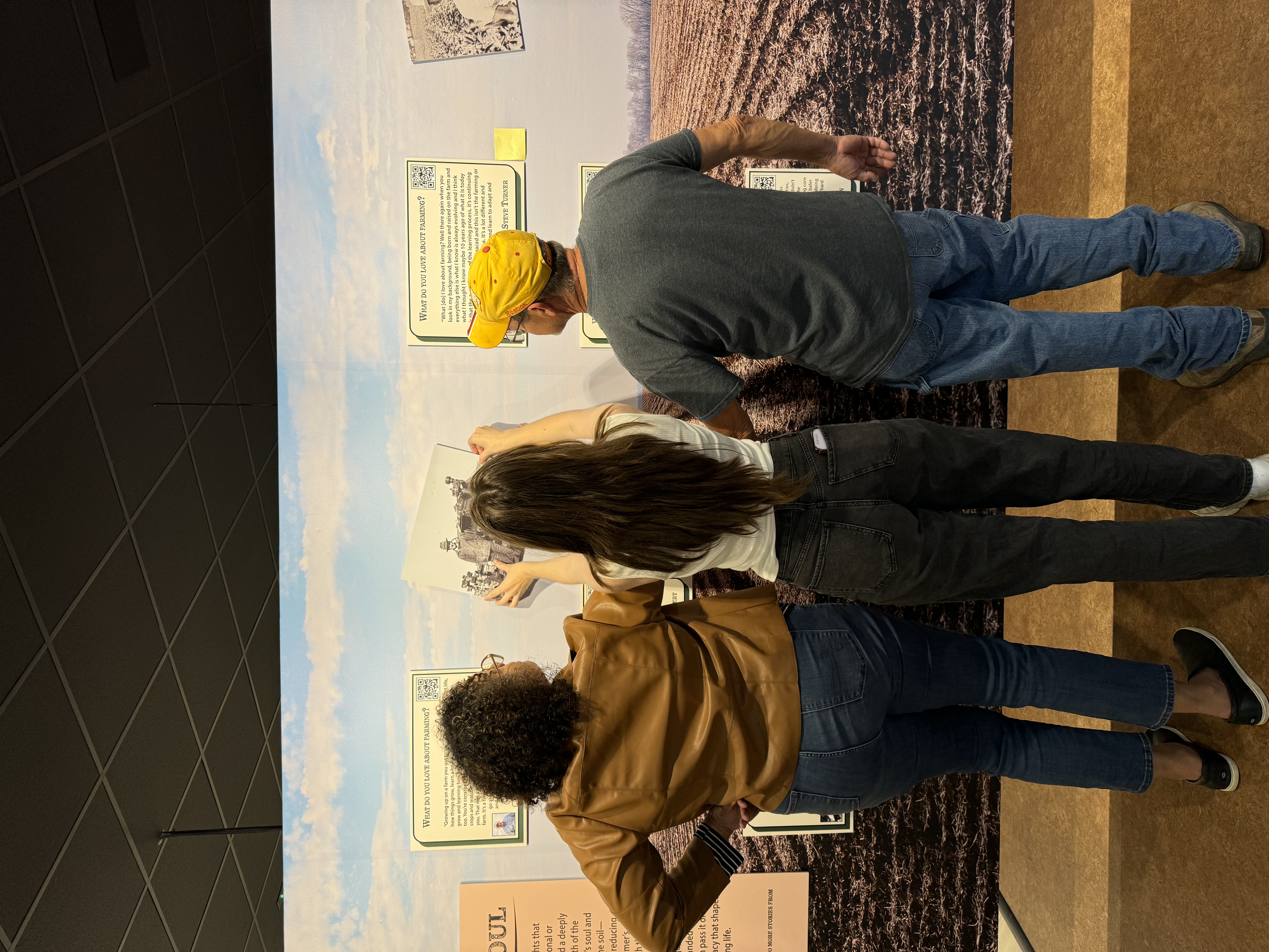 Jenny, Evie and Neville setting up the Soil and Soul exhibit