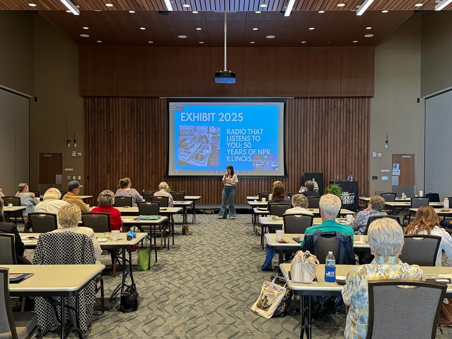 Local History Check-In audience seated in a conference room listening to a presentation.