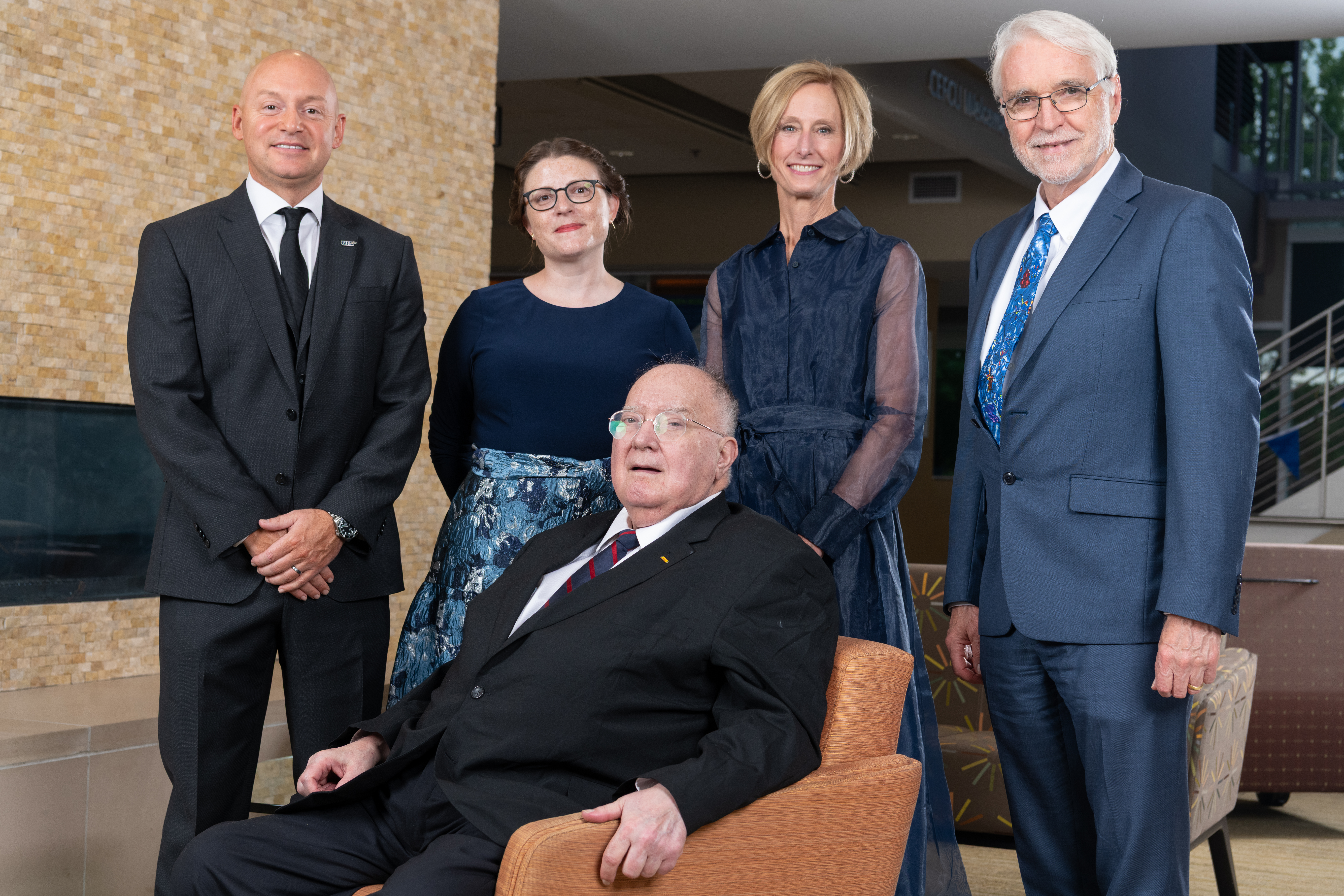alumni achievement award winner posing with UIS and U of I System leadership