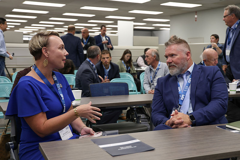Two professionals talking during a campus meeting