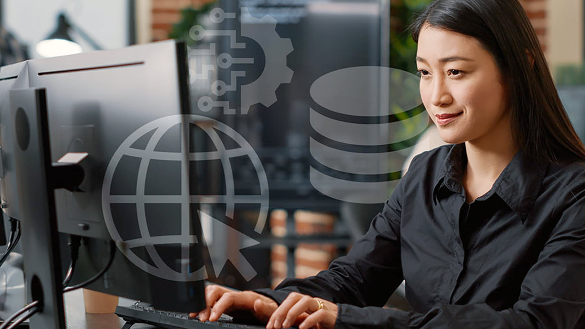 Woman working on a computer in an office setting.