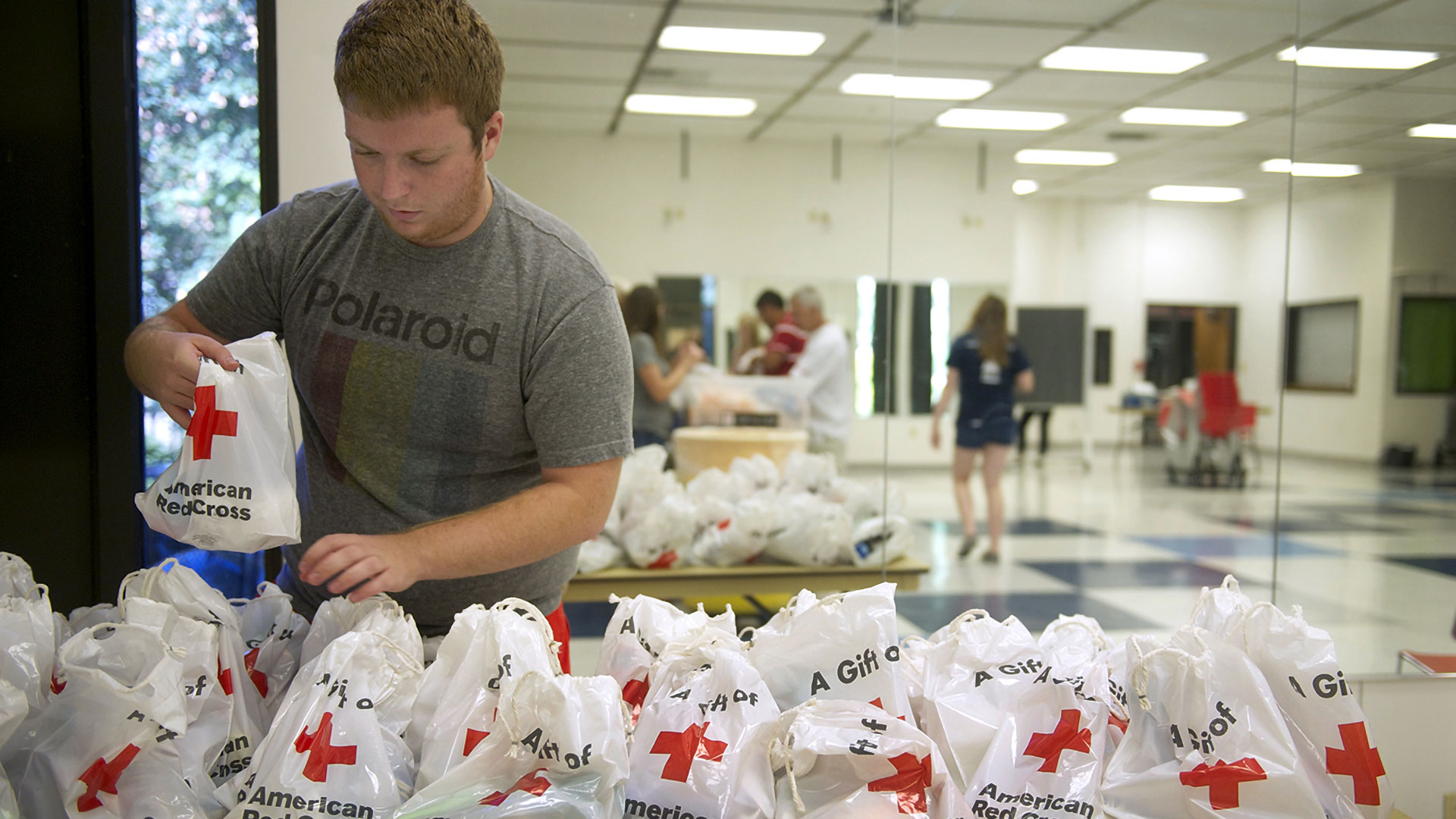 a student volunteer making emergency kits for the Red Cross