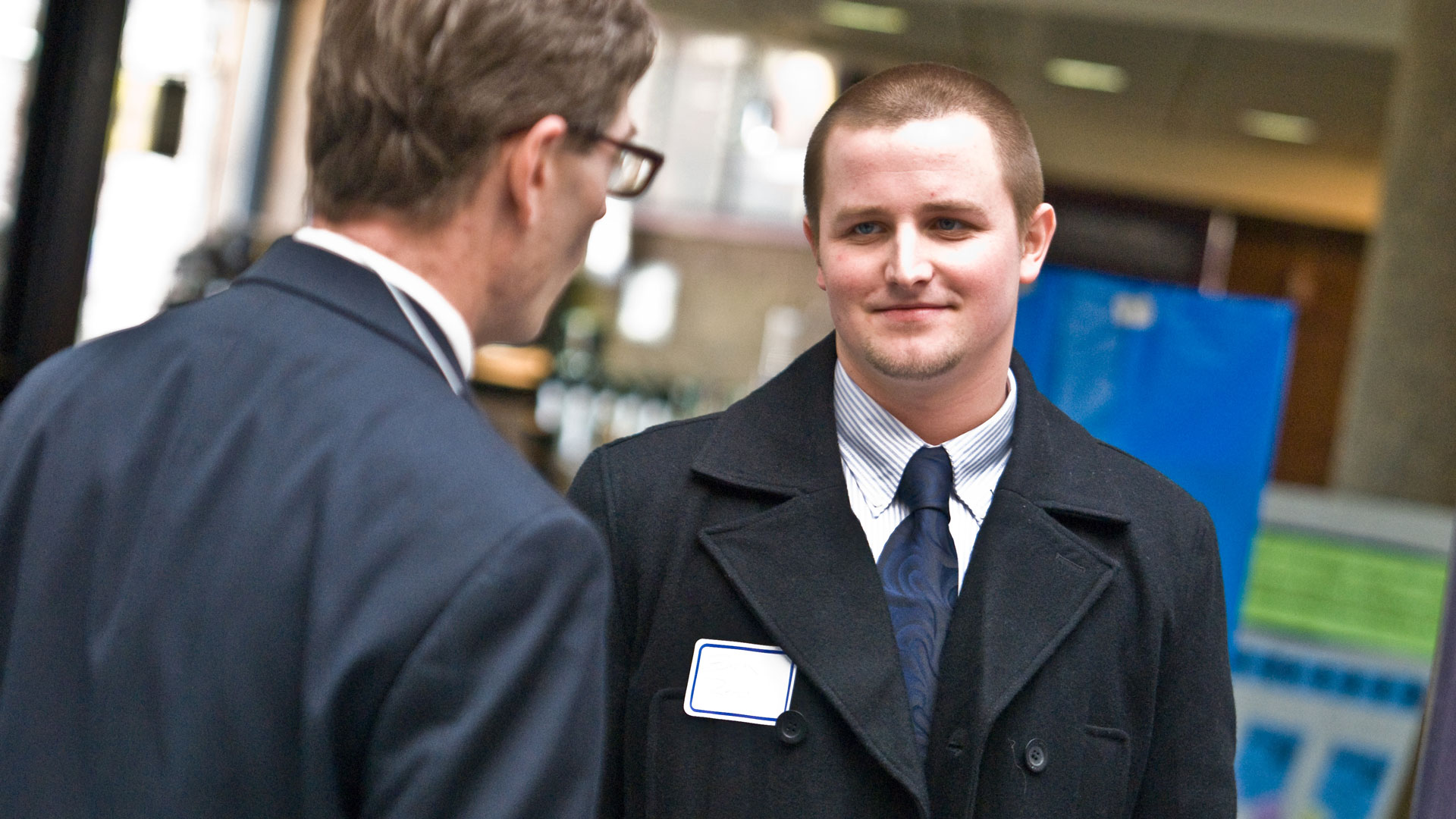 a student talking to a potential employer