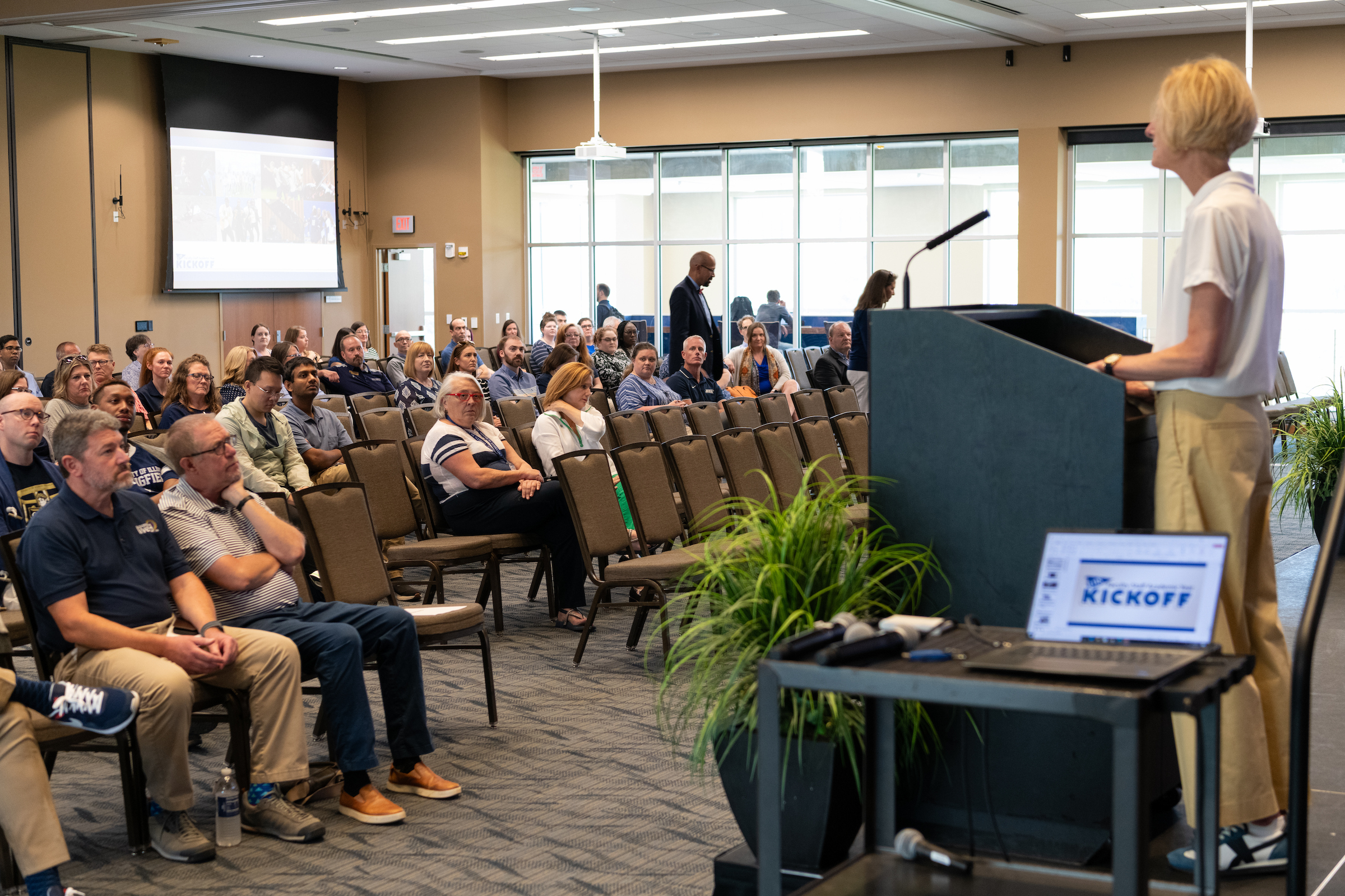 Chancellor Gooch speaks to a room of faculty and staff sitting in chairs. 