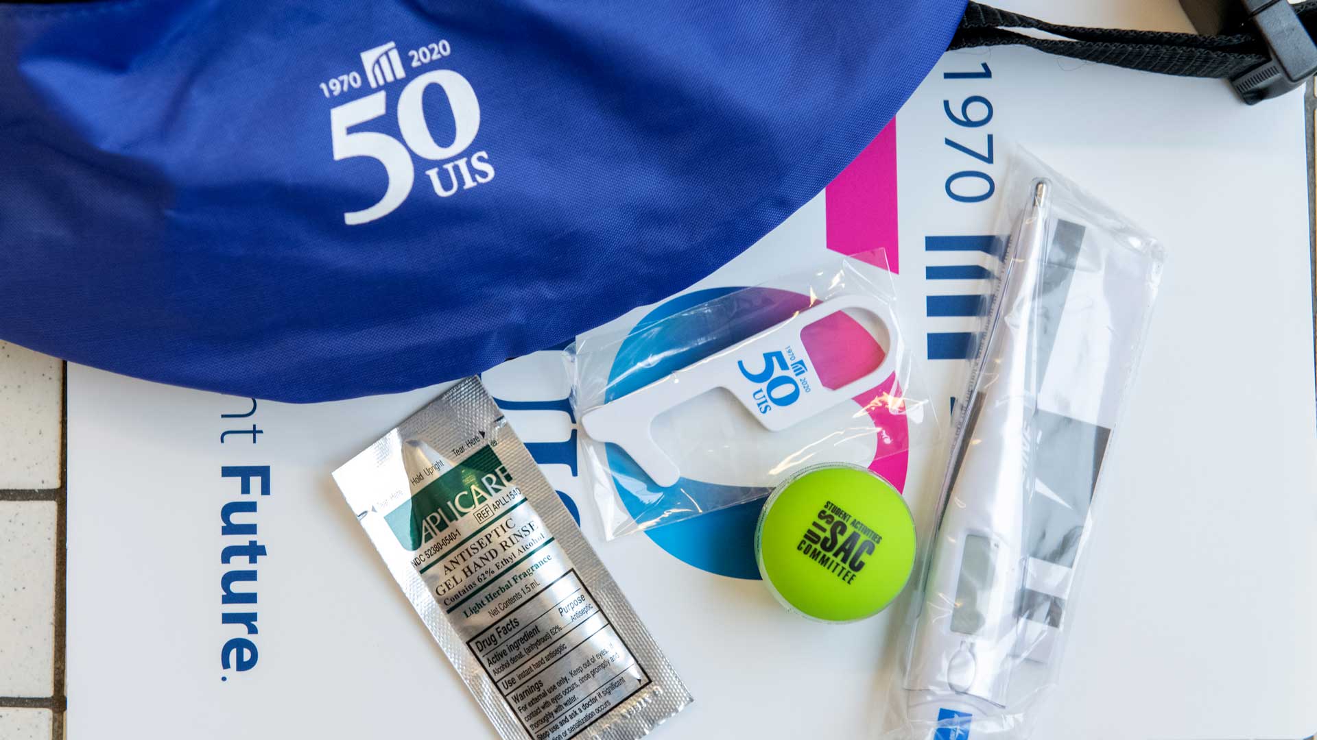 a COVID swag bag filled with things like a thermometer, hand sanitizer, and other heath items