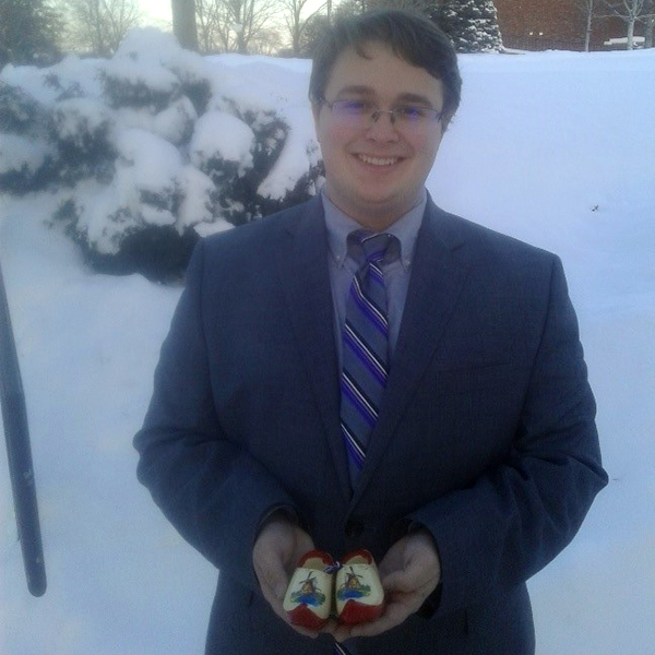 Joseph Partain holding decorative wooden clogs