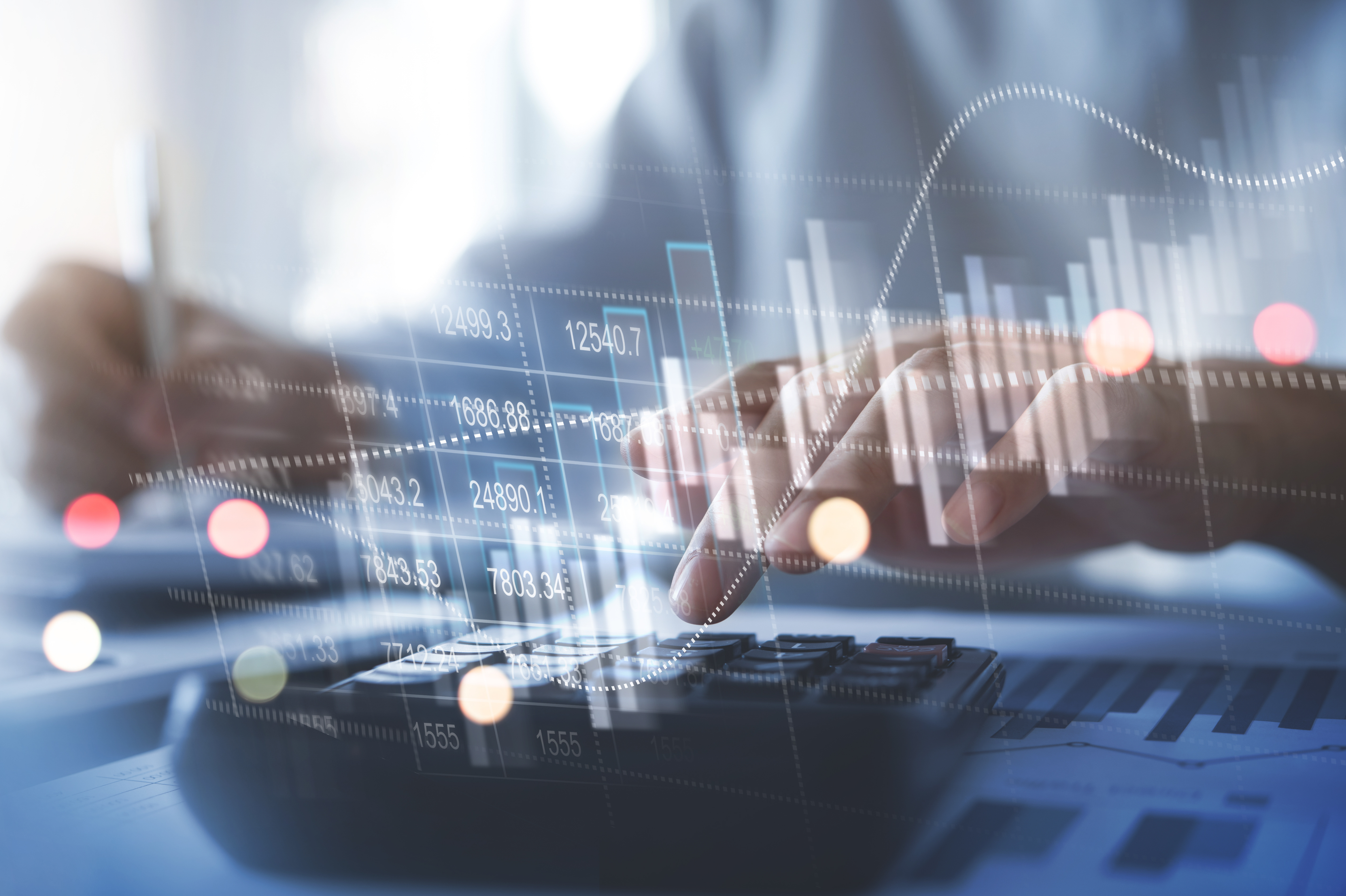 Person analyzing financial data on a computer and calculator