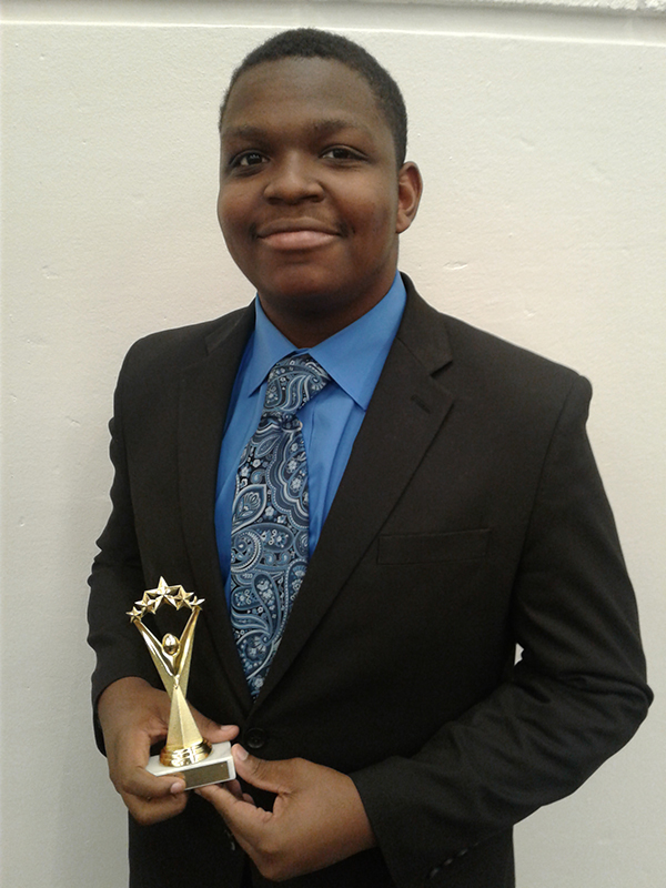 Cedric Birgans holding award