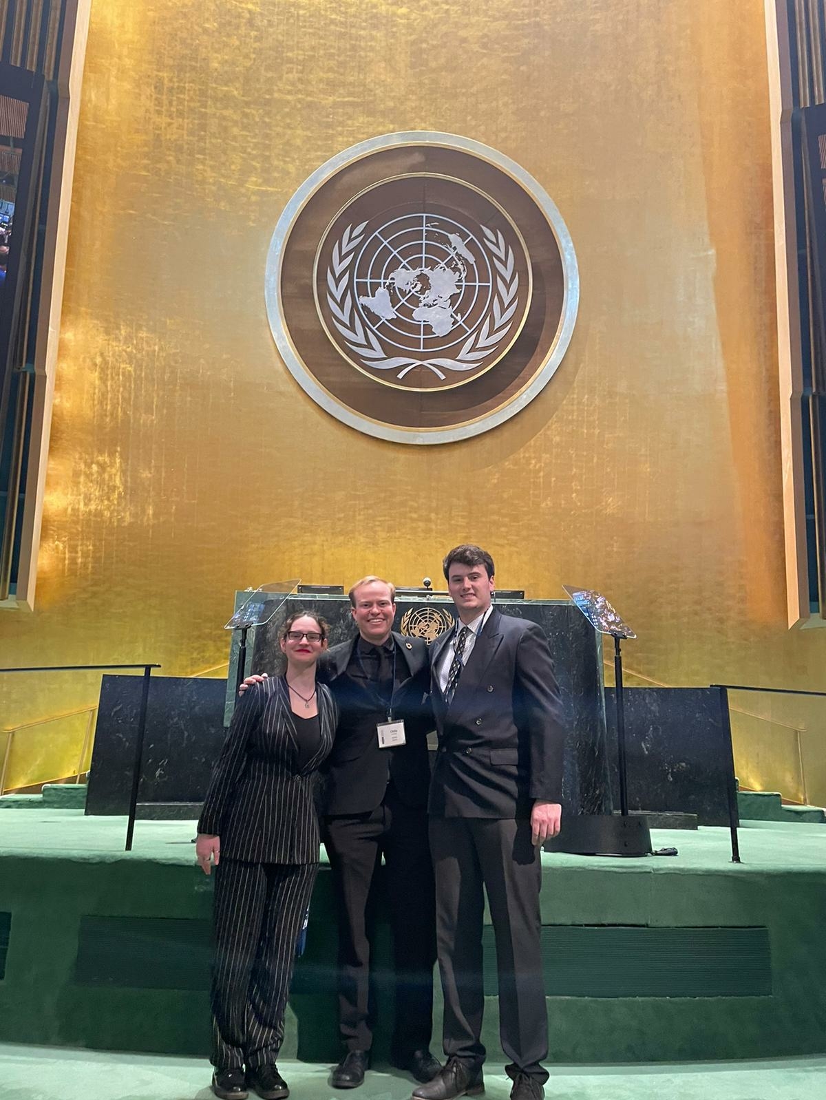 Picture of UIS students in front of the rostrum inside the UN General Assembly Hall.