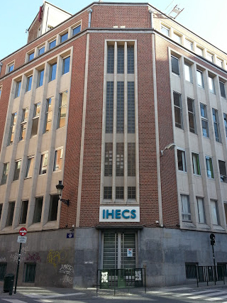 5 story brick building with sign outside: IHECS