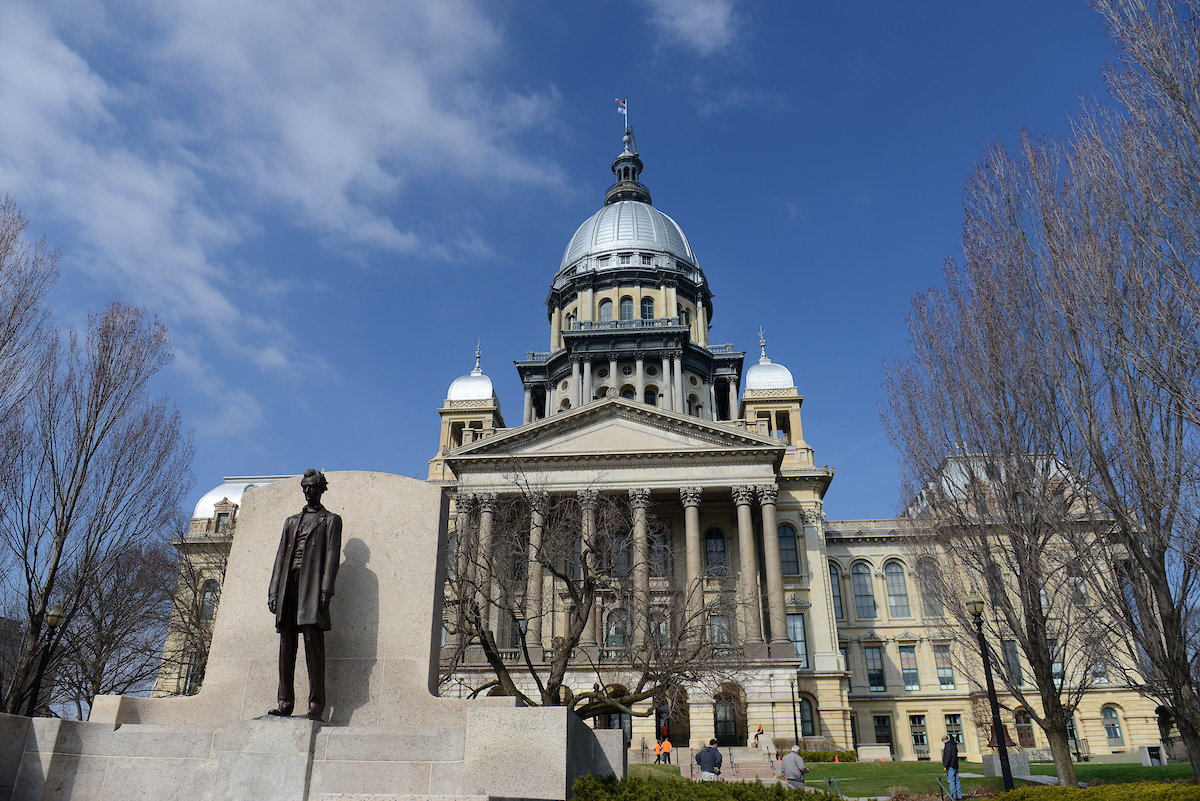 A view of the Illinois State Capitol with the Abraham Lincoln statue out front