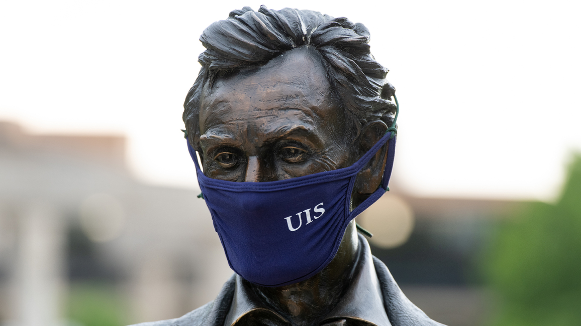 Lincoln statue wearing mask