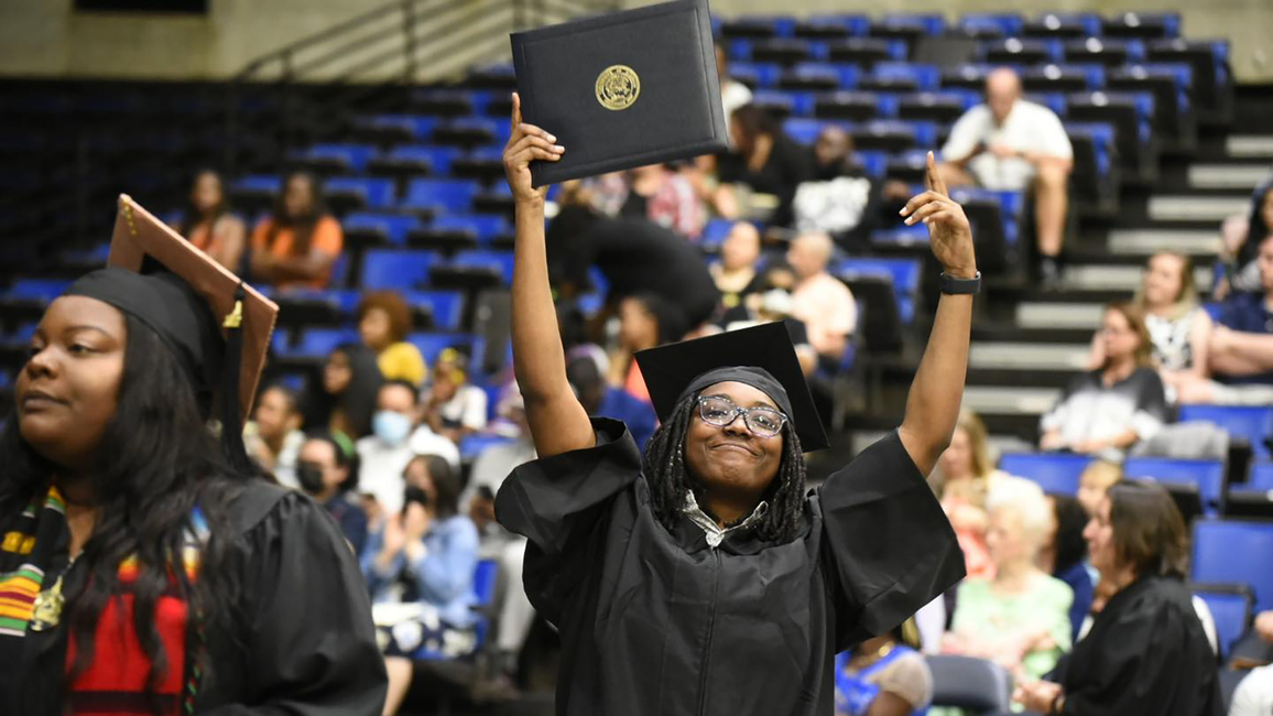 Grad holding diploma