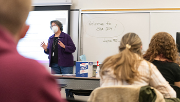Professor teaching in front of a classroom of students