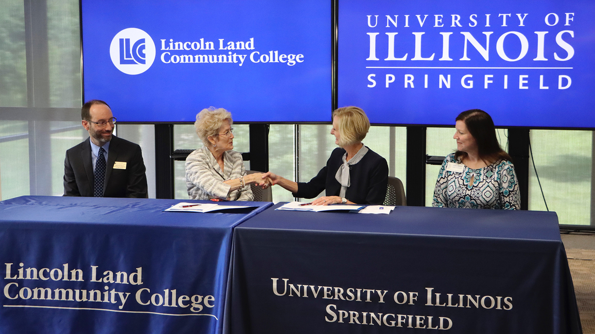 LLCC President Charlotte Warren and UIS Chancellor Janet Gooch shake hands