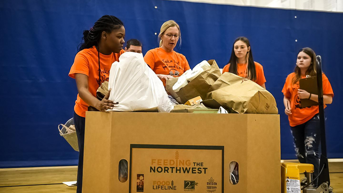 Students with a box of collected food