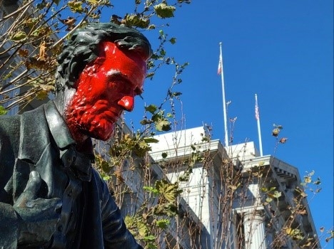 a statue of Lincoln with its face painted red