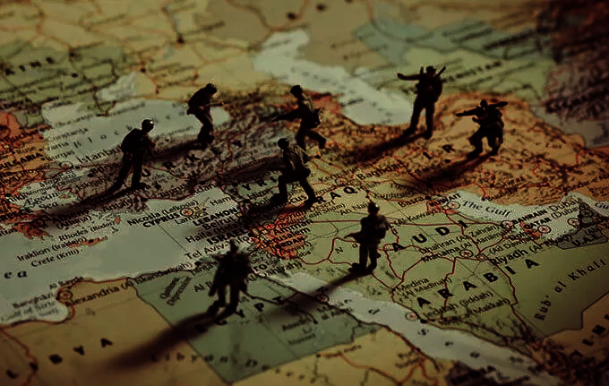 toy solders placed on a map of the Middle East