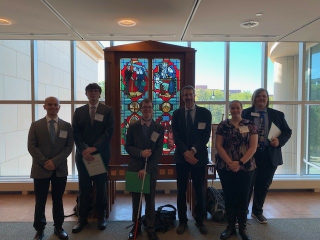 Five students stand next to Professor Peter Shapinsky before presenting at the 2023 Conference on Illinois History.