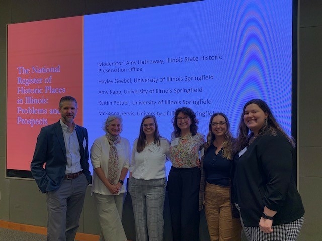 Dr. Devin Hunter, Amy Hathaway (Illinois State Historic Preservation Office) and UIS Public History grad students McKenna Servis, Amy Kapp, Kaitlin Pottier, and Hayley Goebel stand together after the students' presentation at the 2023 Conference on Illinois History.