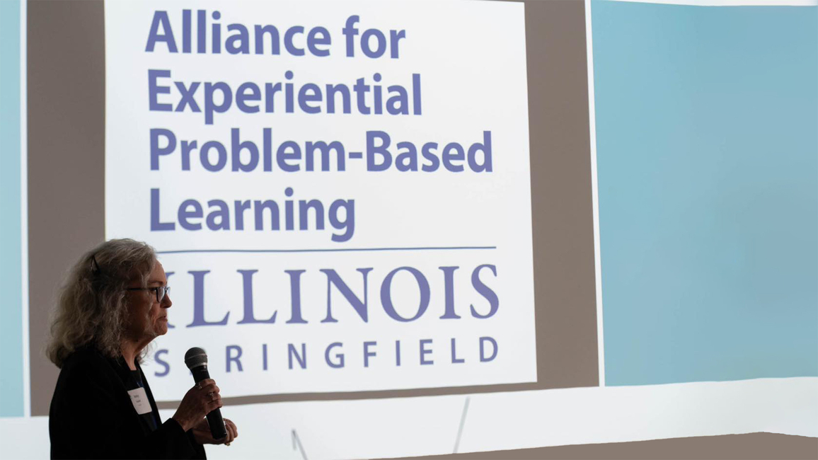 Alliance for Experiential Problem-Based Learning logo on a screen with Betsy Goulet talking