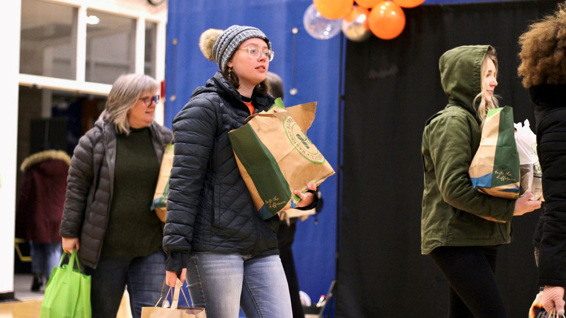 Student holding bags of food