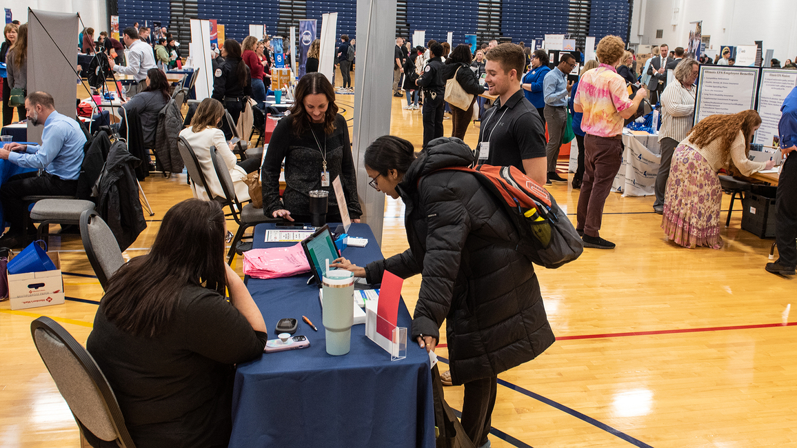 Students filling out papers at the Career Connections Expo