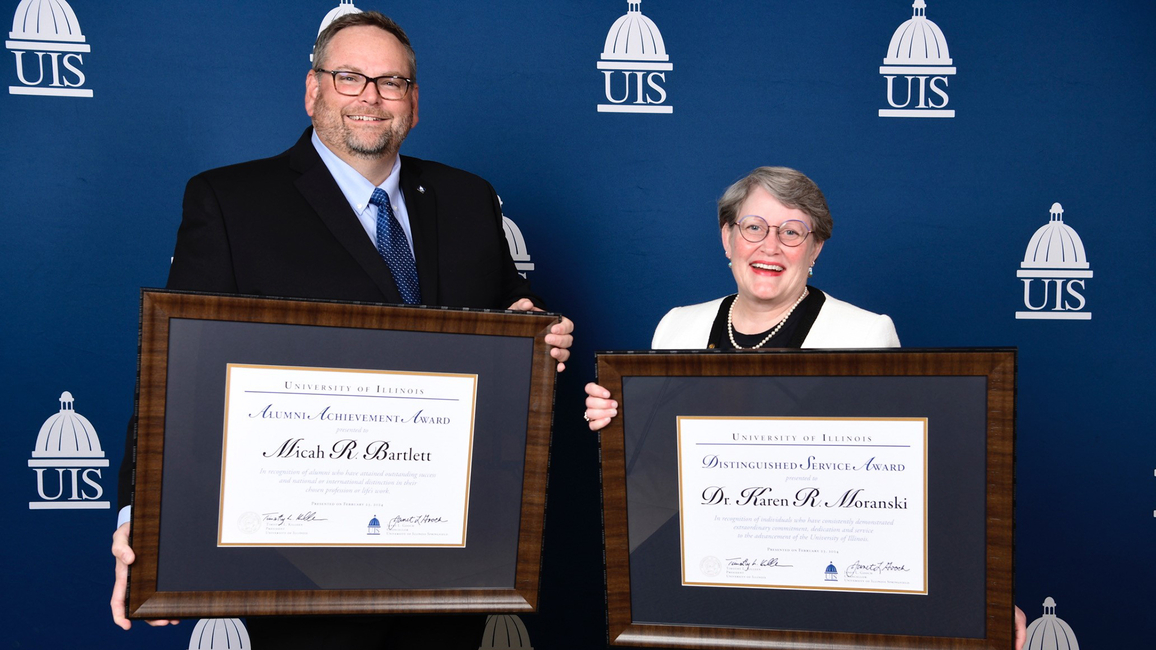 Micah Bartlett and Karen Moranski holding their awards