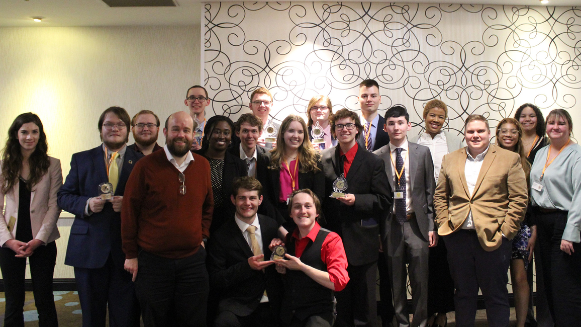 The UIS Model Illinois Government delegation poses for a group photo, holding awards.