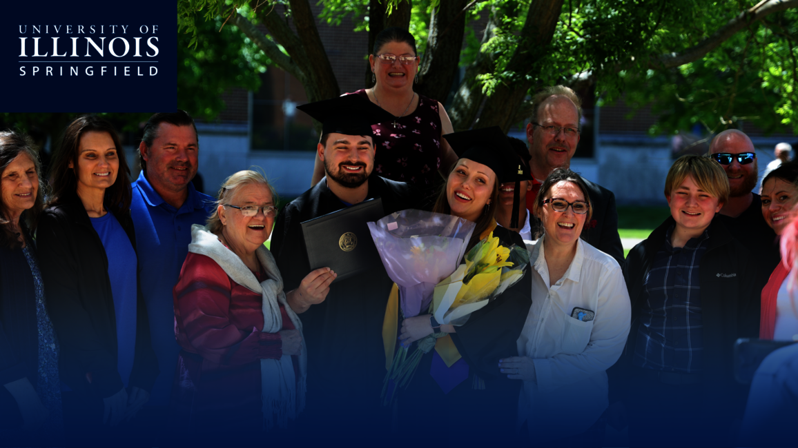 A family taking a picture at graduation.